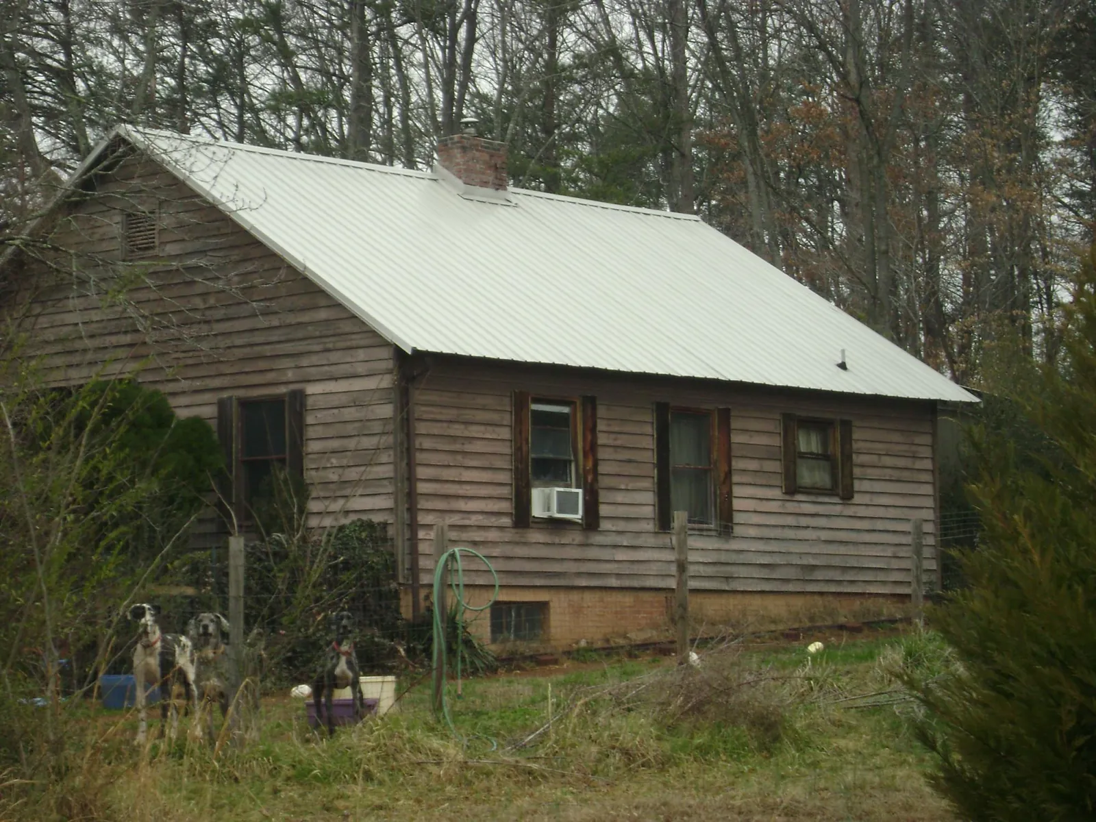 White metal roof on an old wood sided farmhouse, from a Metal Roof Installation job in Pawlet